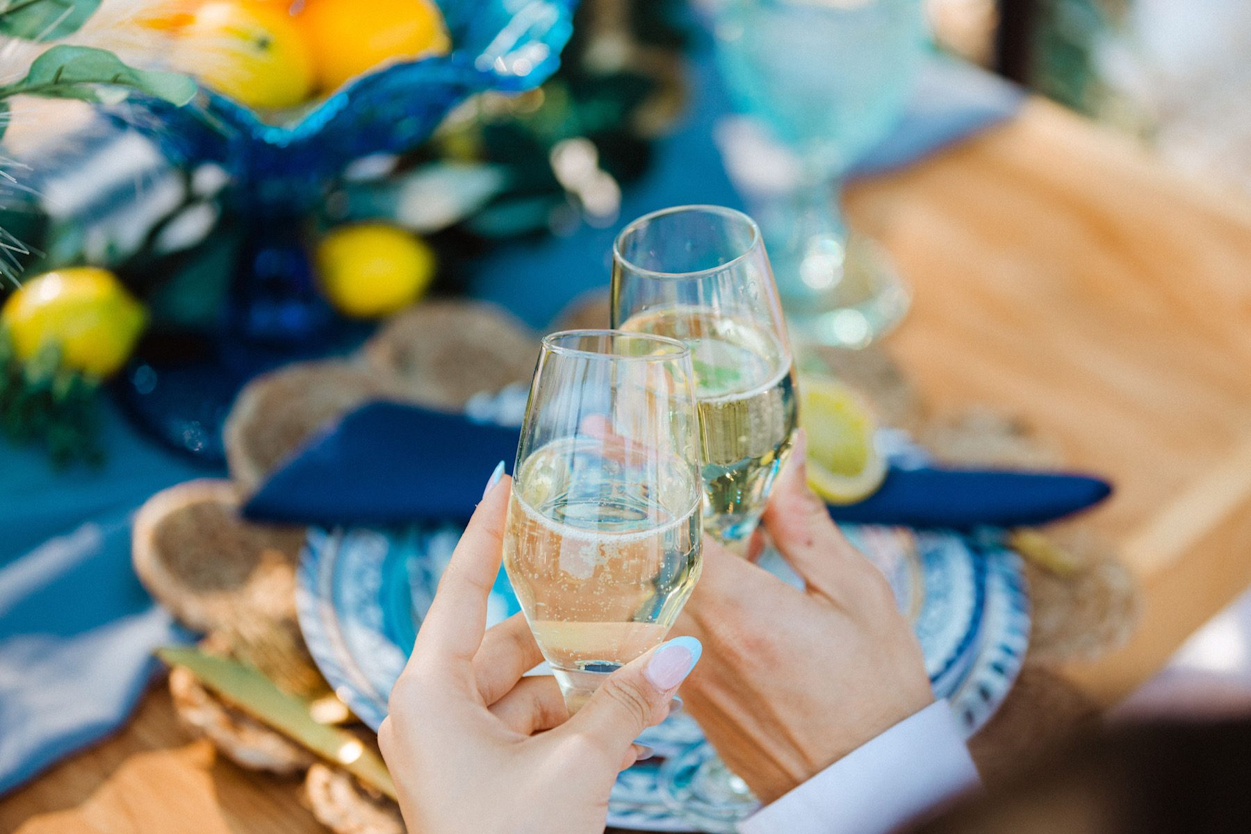 Champagne toast at a lemon and blue themed celebration